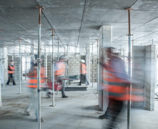six-blurred-construction-workers-on-the-go-in-busy-2022-03-07-23-57-53-utc